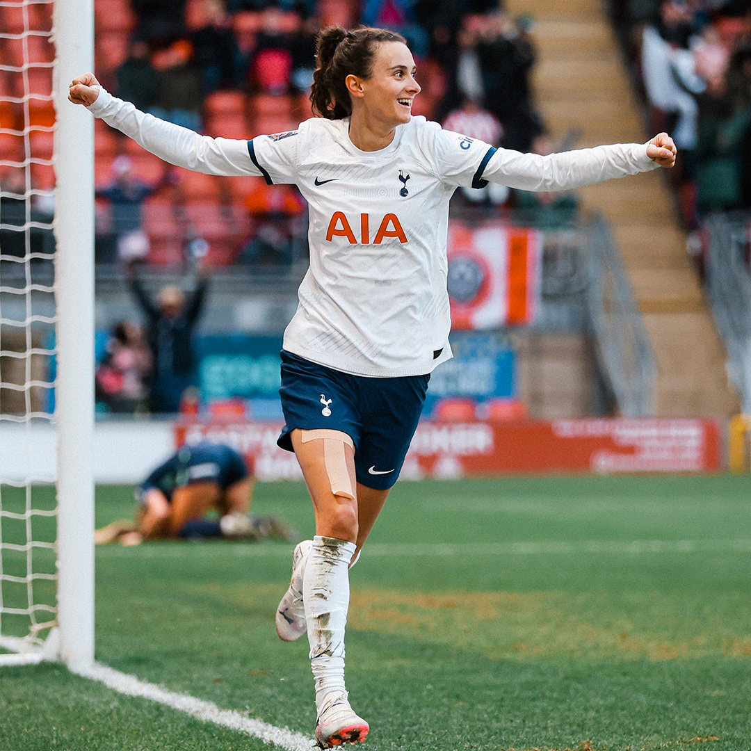 Rosella Ayane spreads her arms in celebration after scoring the game-winning goal.