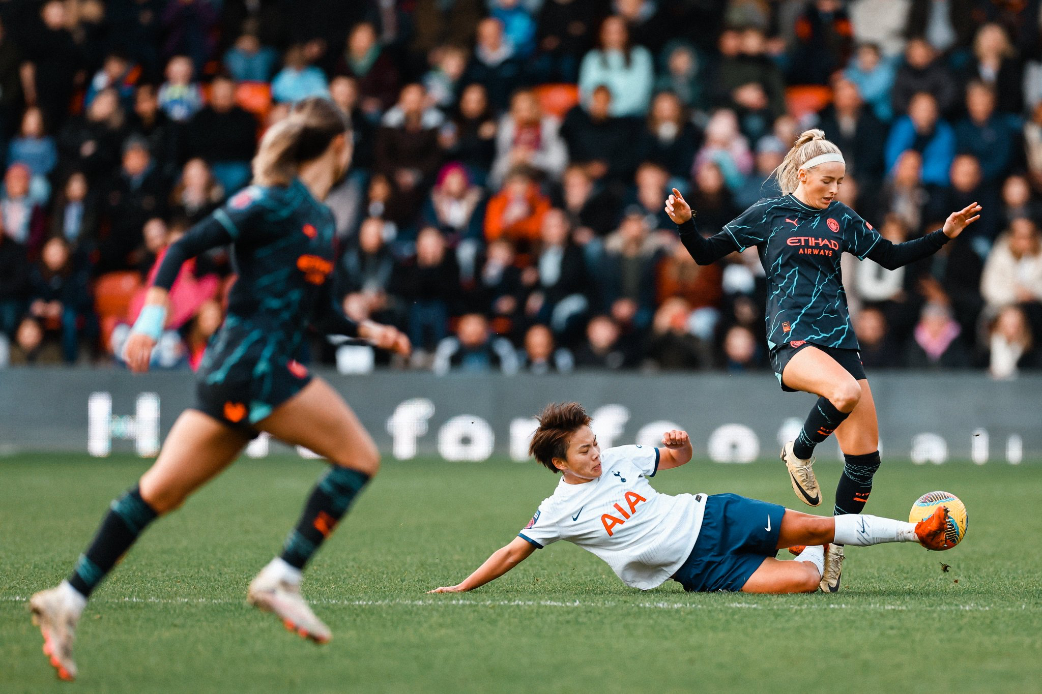 Shuang Wang goes in for a slide tackle on Chloe Kelly.