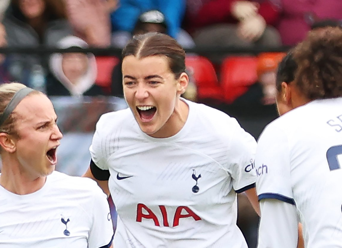 Angharad James shouts in celebration behind Martha Thomas as Drew Spence looks on.