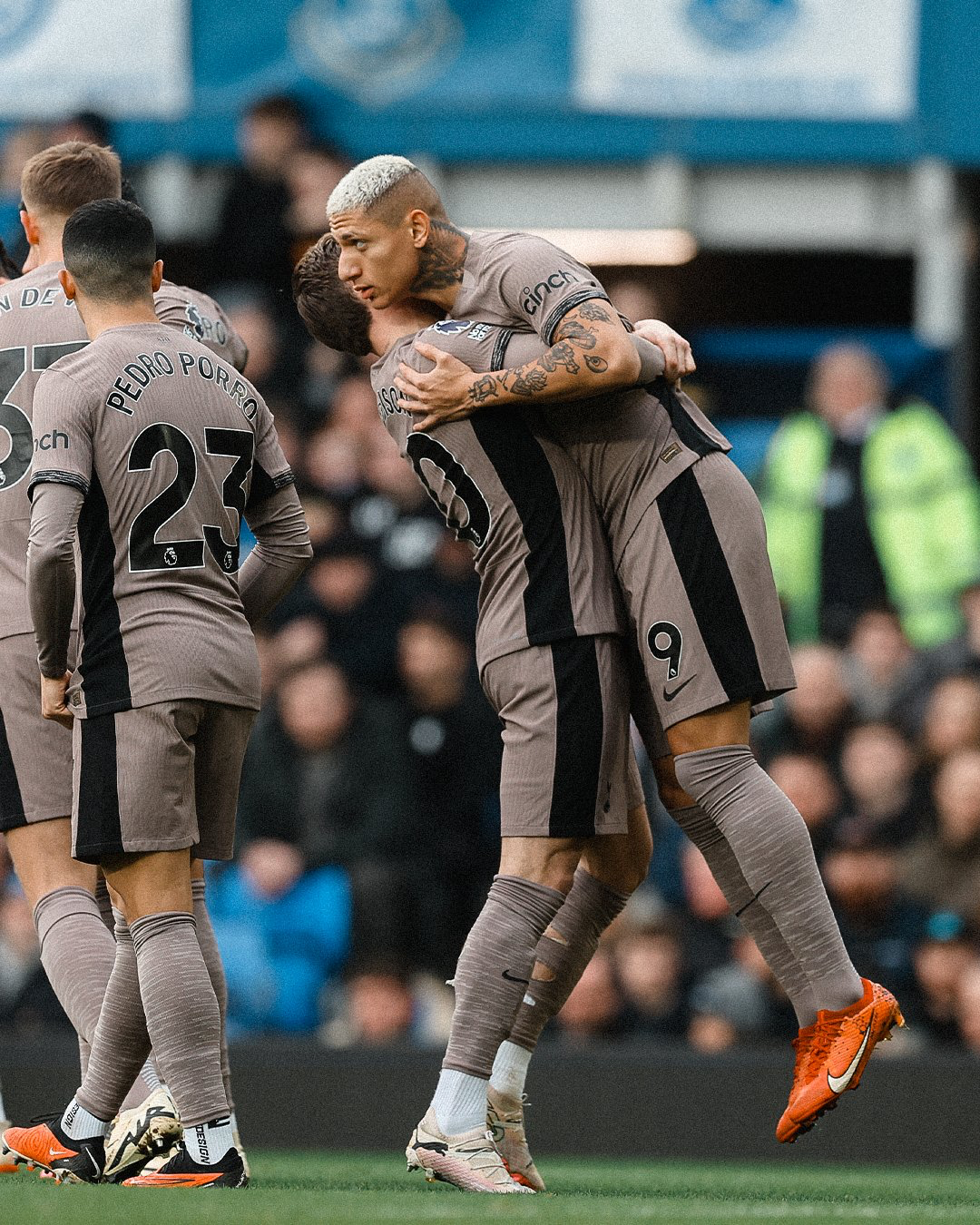 James Maddison lifts Richarlison up into the air while hugging him.