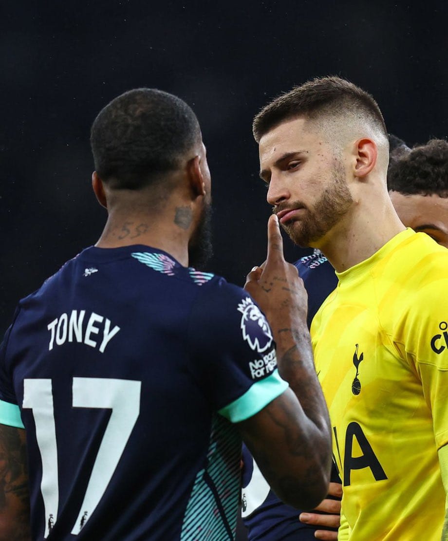 Guglielmo Vicario frowns as Ivan Toney holds up a finger in his face.