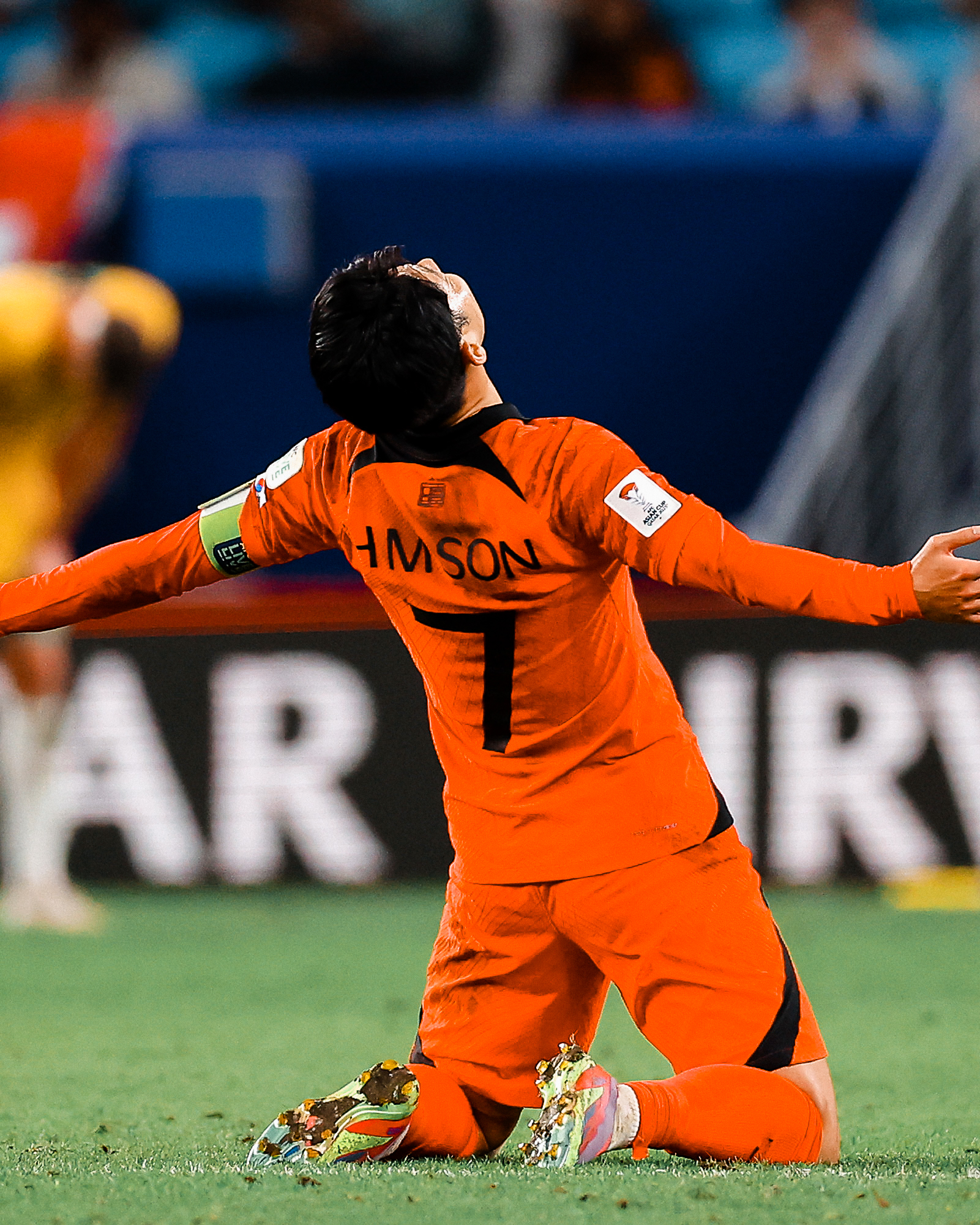 Son Heung-min falls to his knees to celebrate South Korea's win over Australia in the Asian Cup.