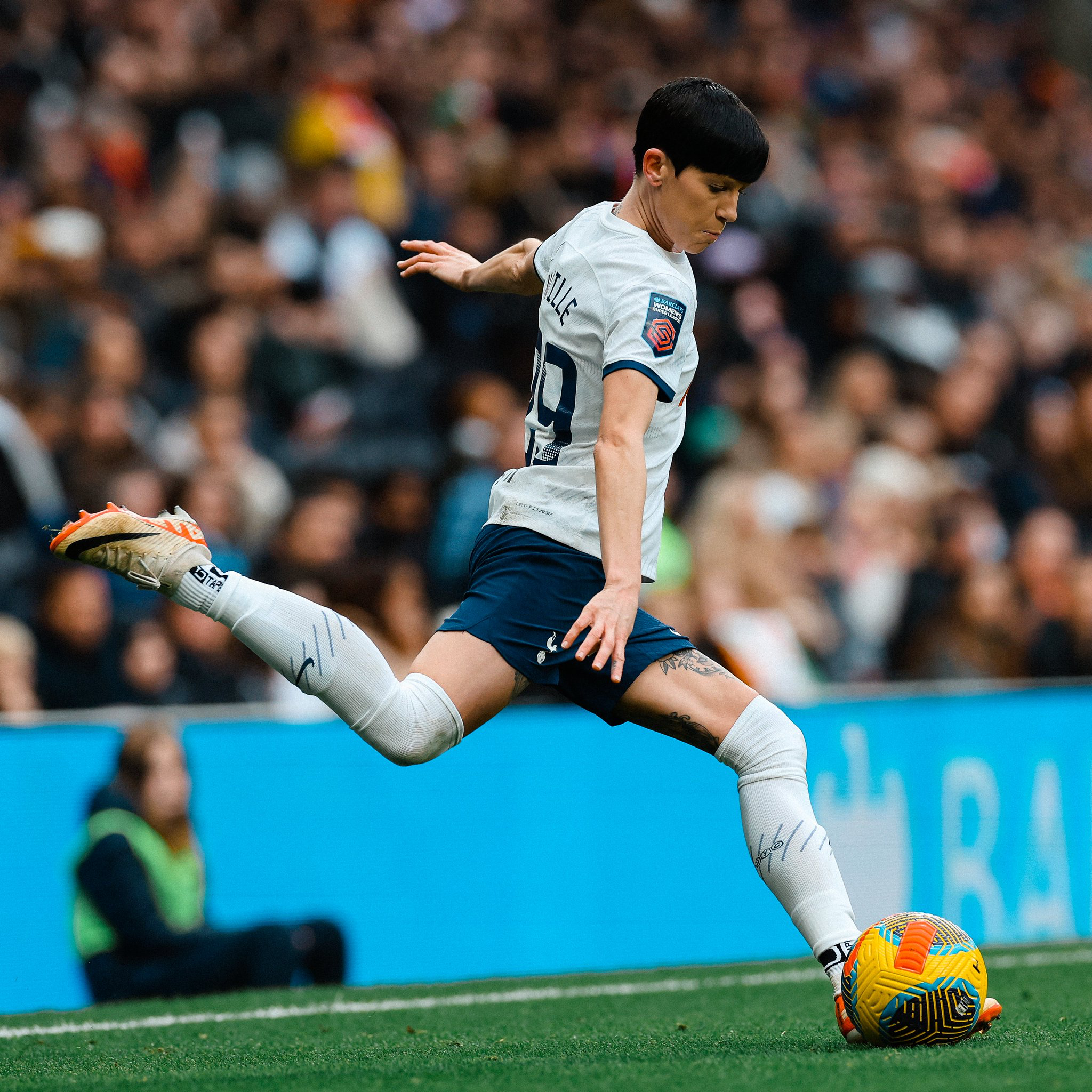 Ashleigh Neville winds up to kick the ball.