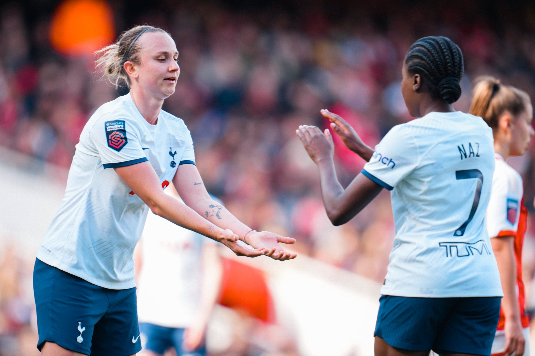 Martha Thomas holds out her hands to high-five Jess Naz.