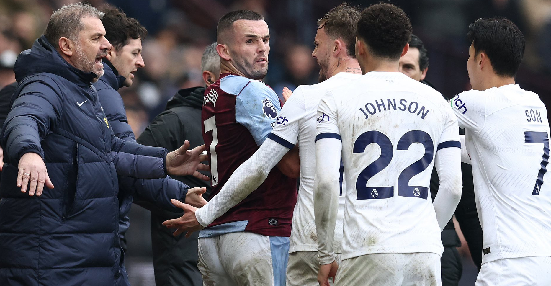 John McGinn argues with Spurs players after receiving a red card.