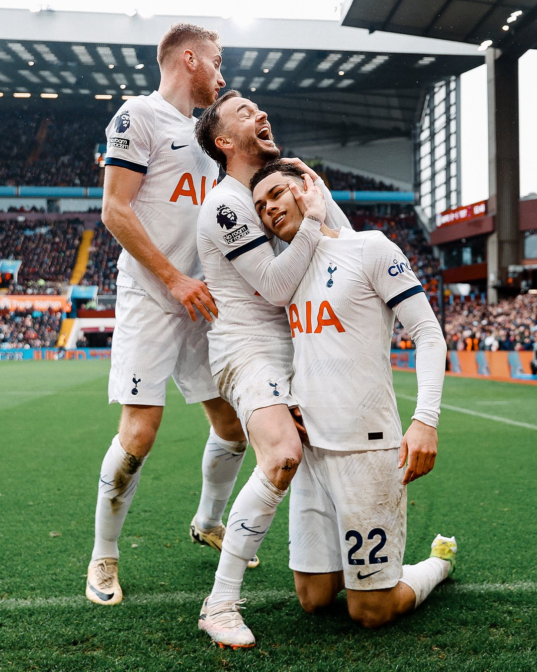 James Maddison hugs a kneeling Brennan Johnson as Dejan Kulusevski looks on.