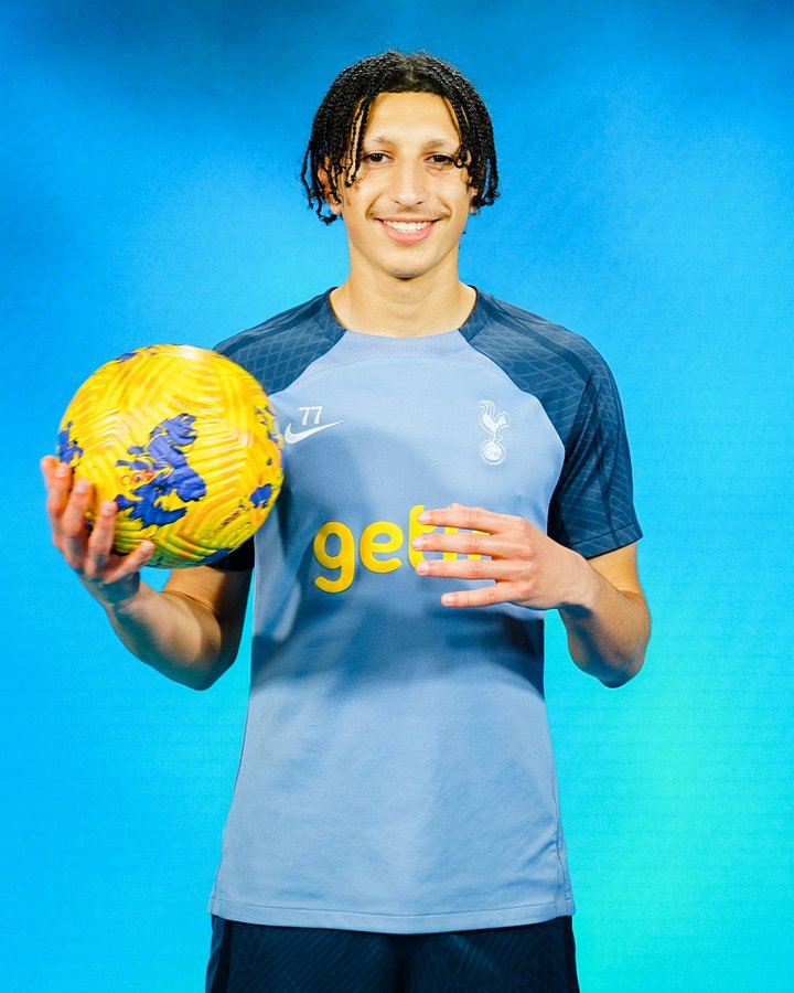 Yusuf Akhamrich poses with a ball to celebrate signing his first pro contract.