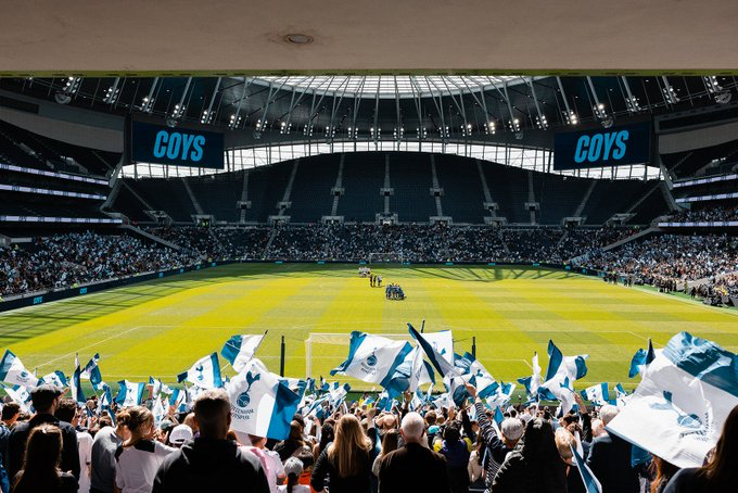 Spurs fans wave flags at Tottenham Hotspur Stadium for the FA Cup semi-final.