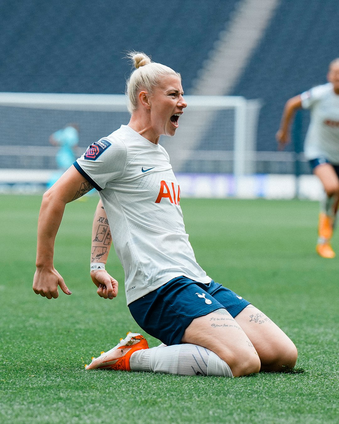 Beth England celebrates her opening goal with a knee slide.