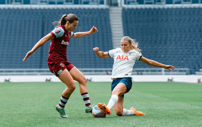 Charli Grant goes in for a slide tackle on a West Ham player.