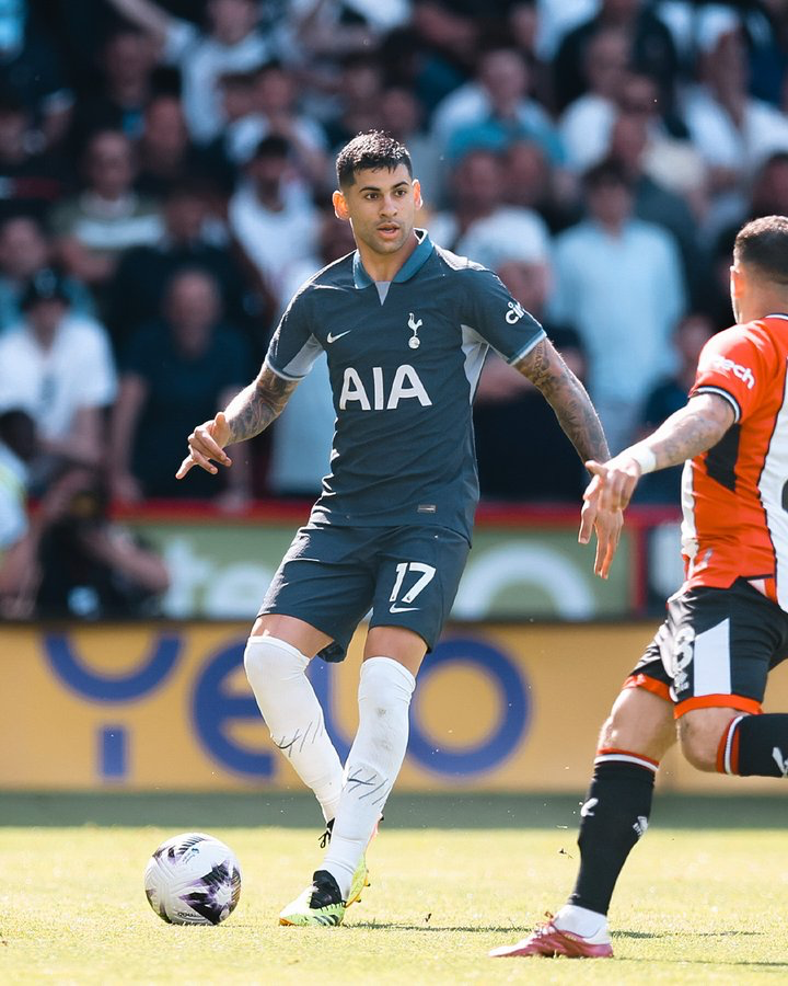 Cristian Romero surveys the pitch for a pass.