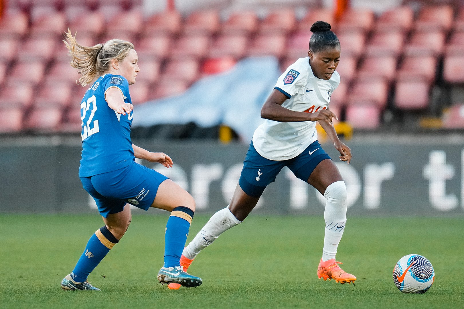 Jess Naz dribbles past Erin Cuthbert.