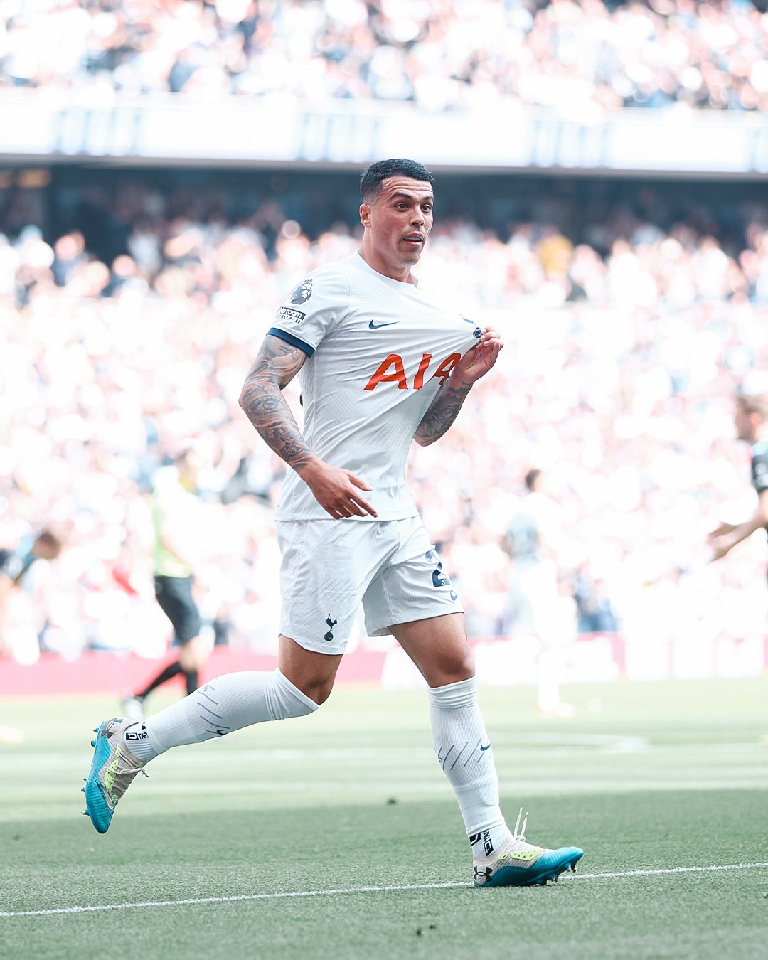 Pedro Porro holds up the Tottenham badge on his kit after scoring.