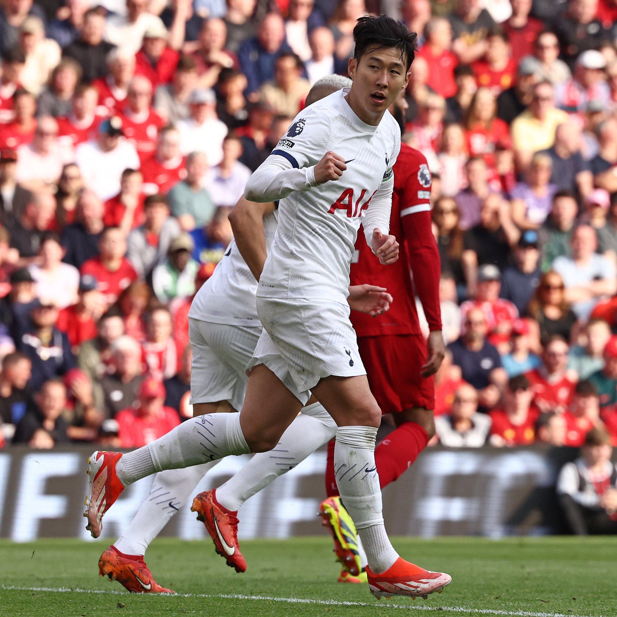 Son Heung-min celebrates his goal against Liverpool with a raised fist.