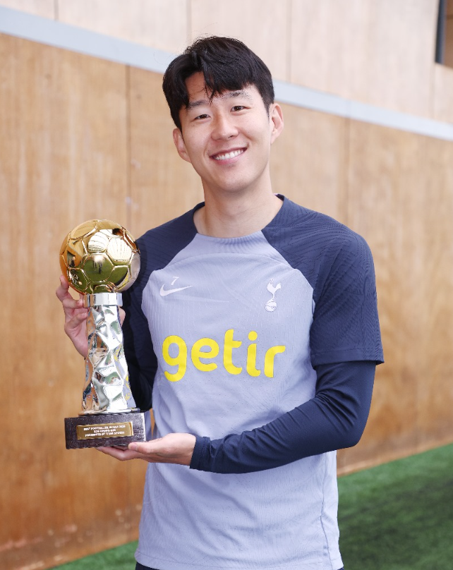 Son Heung-min holds up his trophy for Best Footballer in Asia 2023.