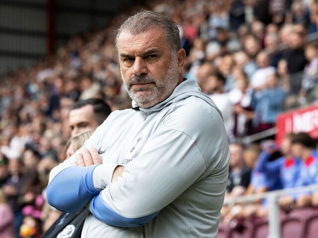 Ange Postecoglou crosses his arms on the sideline.