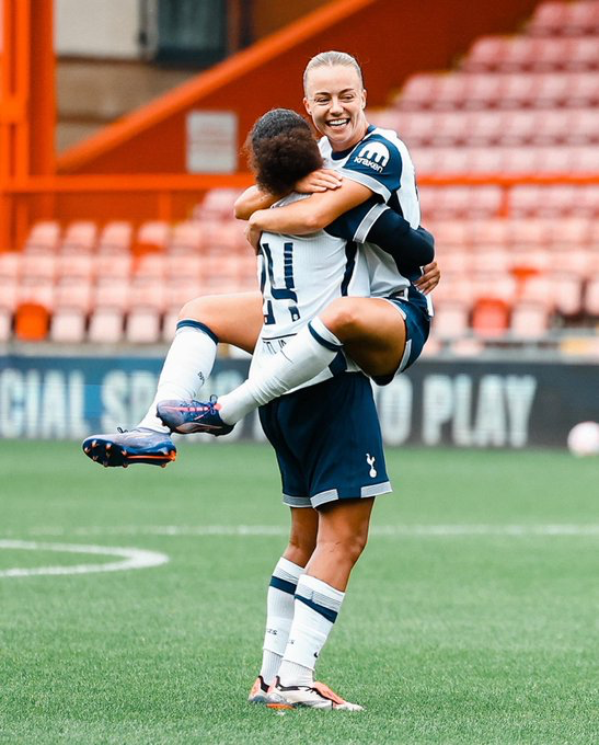 Olga Ahtinen jumps into Drew Spence's arms to celebrate a goal.