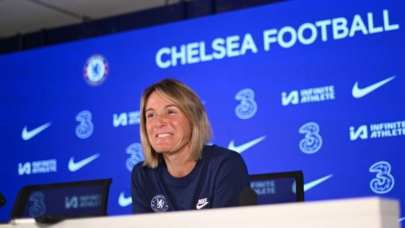 Sonia Bompastor smiles at a Chelsea press conference.