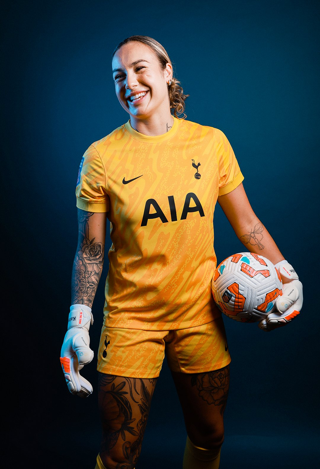 Katelin Talbert poses in her keeper gloves with a ball in her left hand.