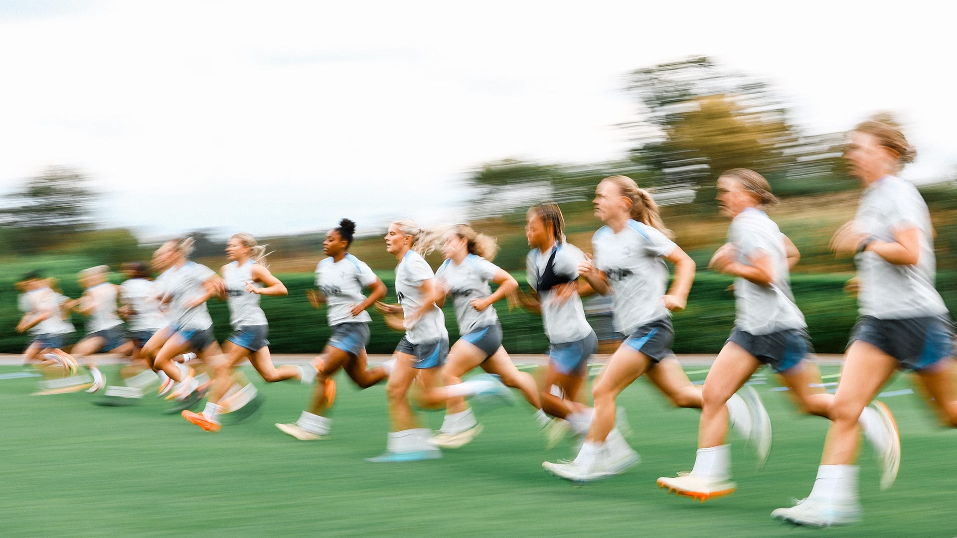 A blurry photo of players in motion on a running drill.