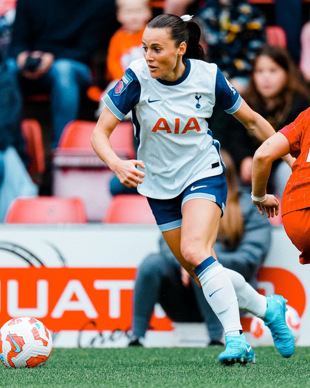 Hayley Raso dribbles past a Liverpool player. 