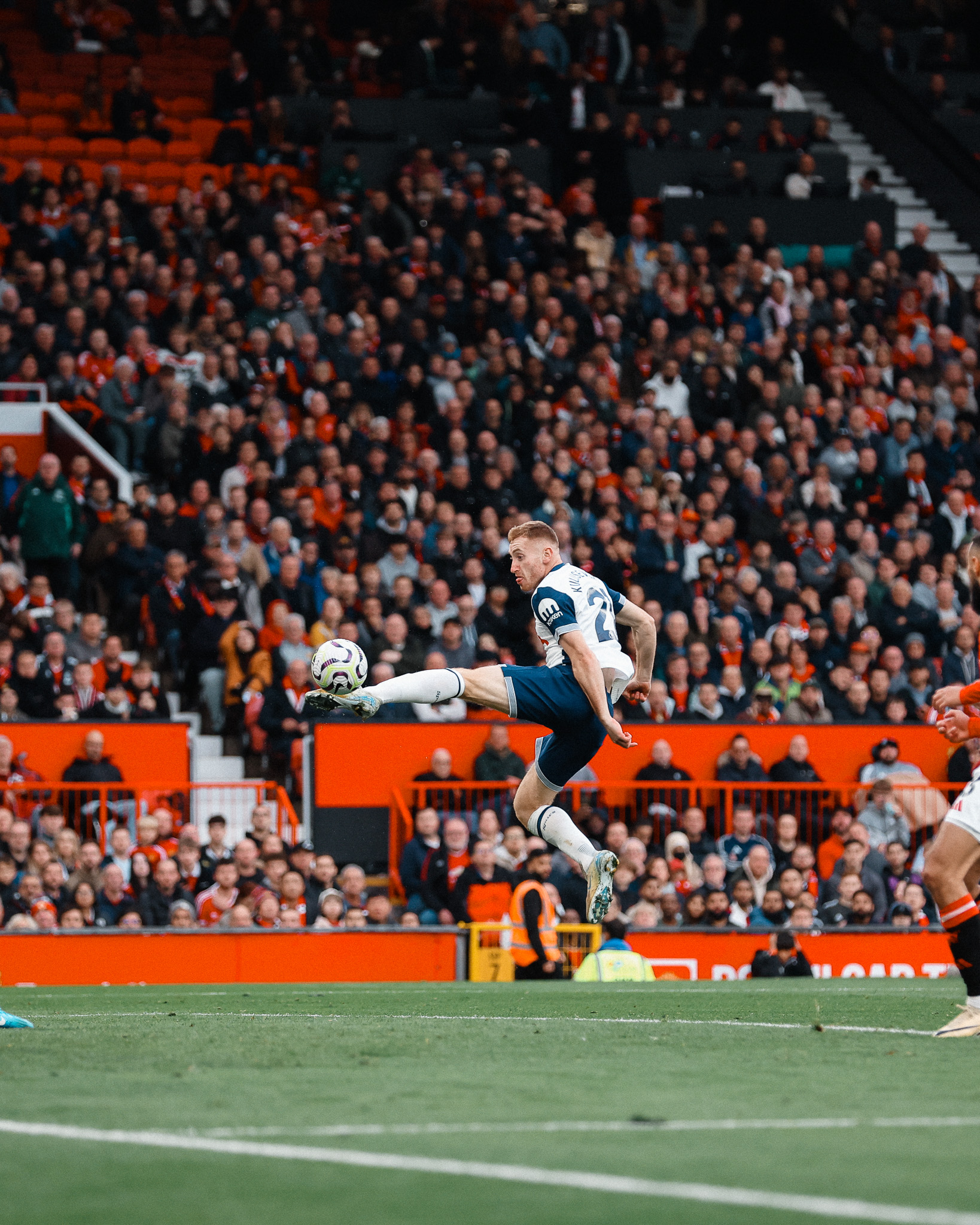 Dejan Kulusevski leaps up to volley the ball into the net.