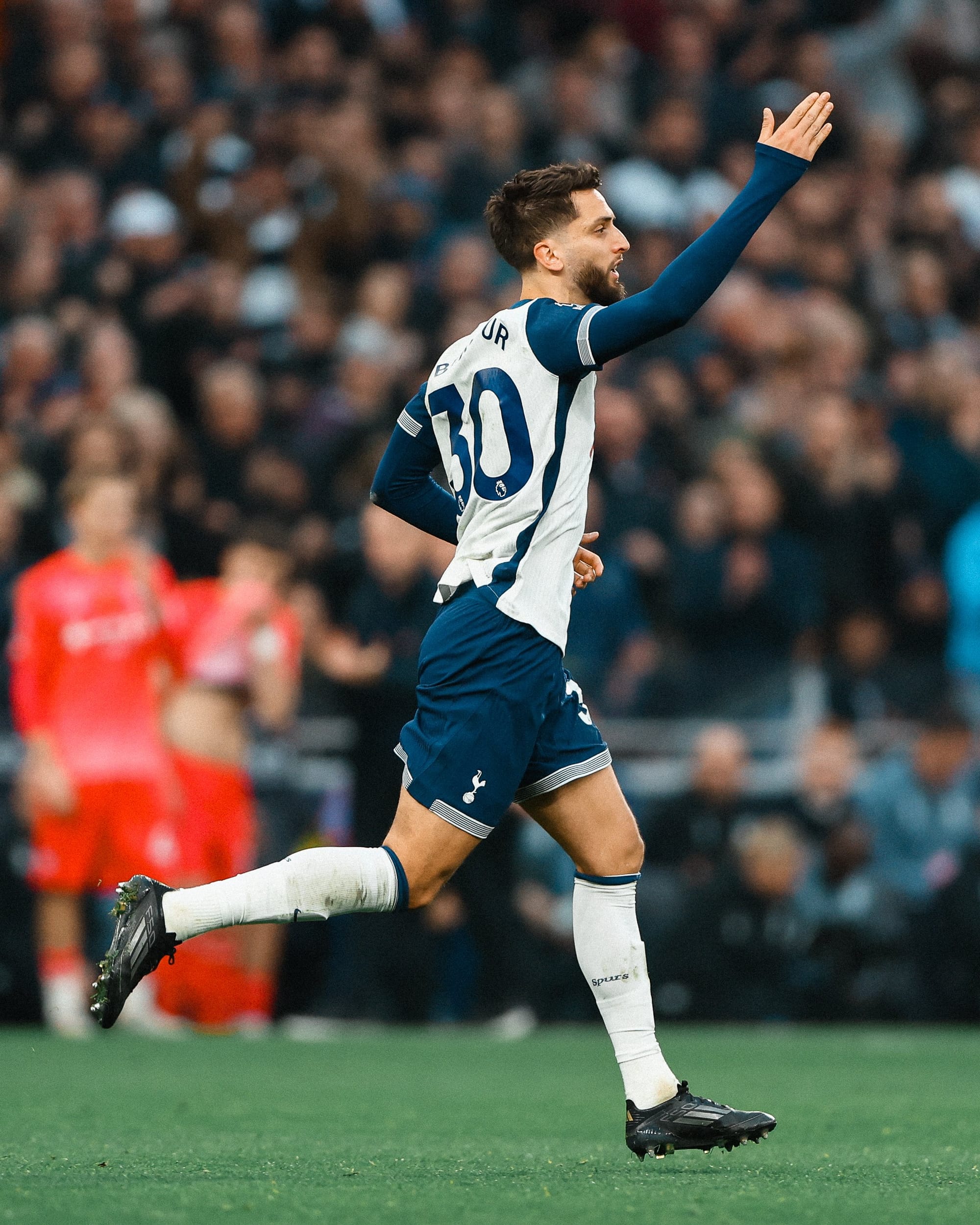 Rodrigo Bentancur holds his hand up to celebrate his first goal of the season.