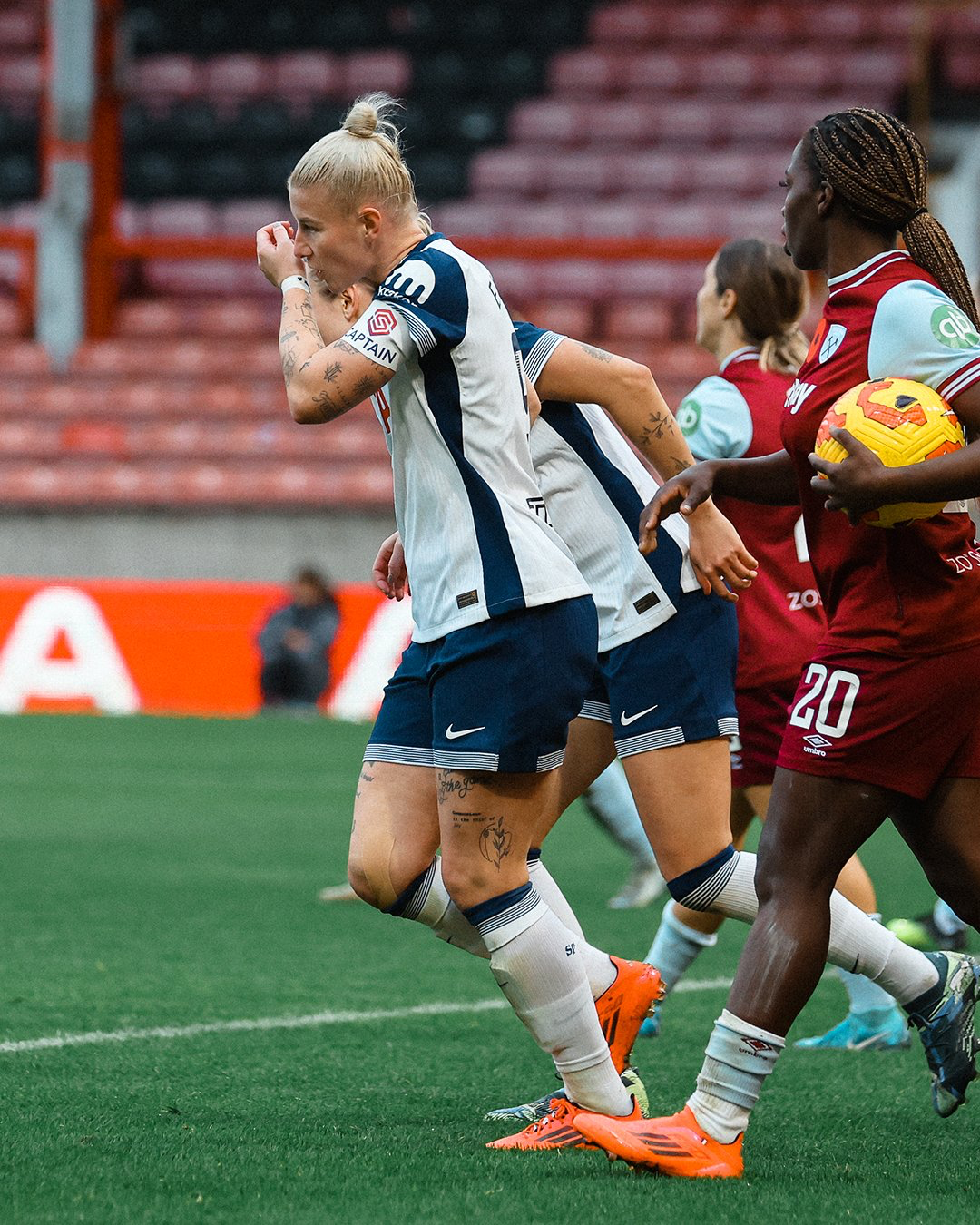 Beth England kisses her wristband after scoring.