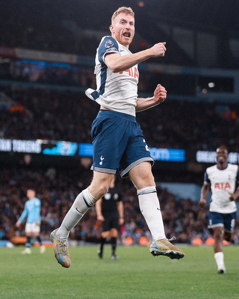 Dejan Kulusevski jumps in the air to celebrate a teammate's goal. 