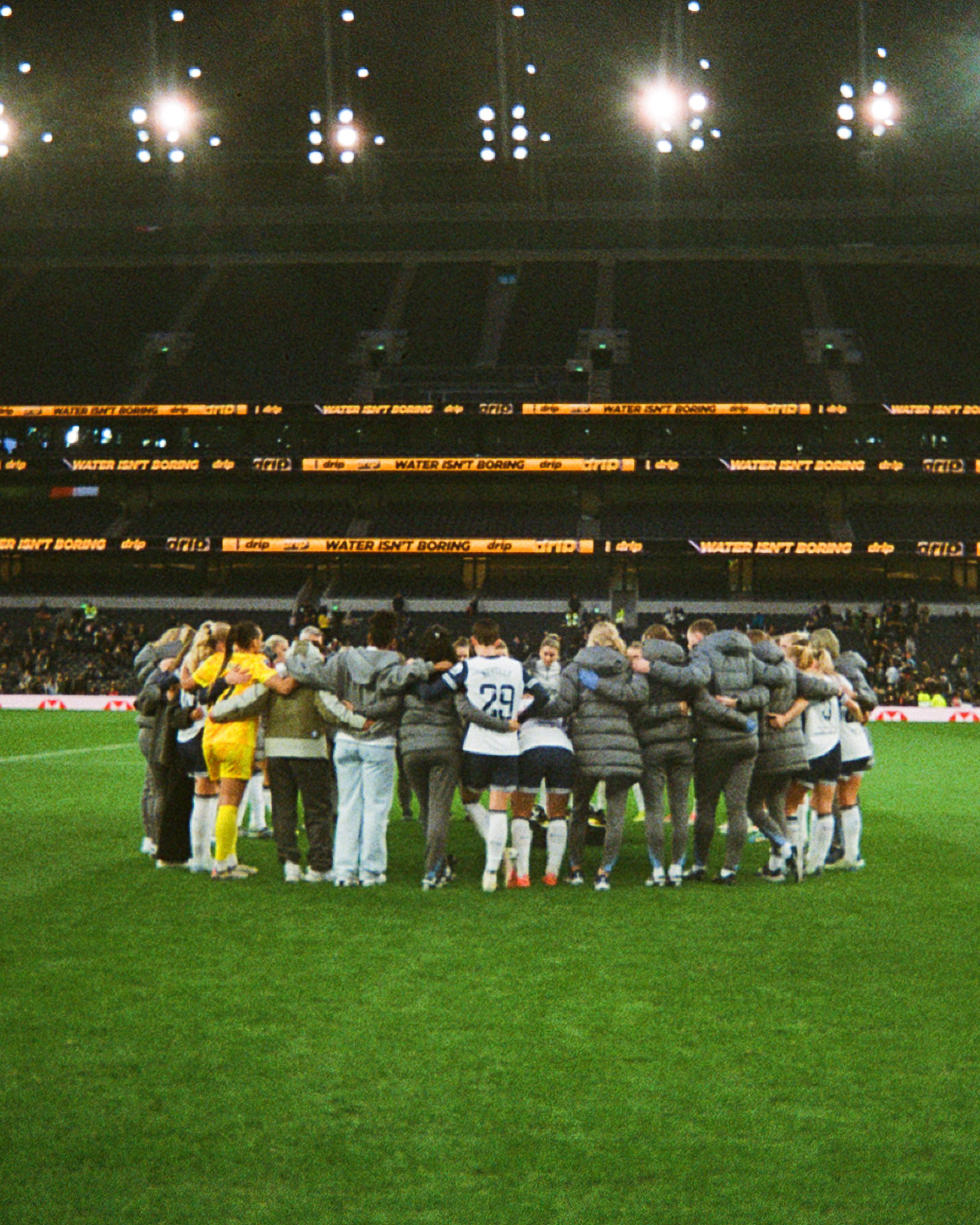 A film image of Spurs Women huddling after the NLD loss in the emptying THS stadium.