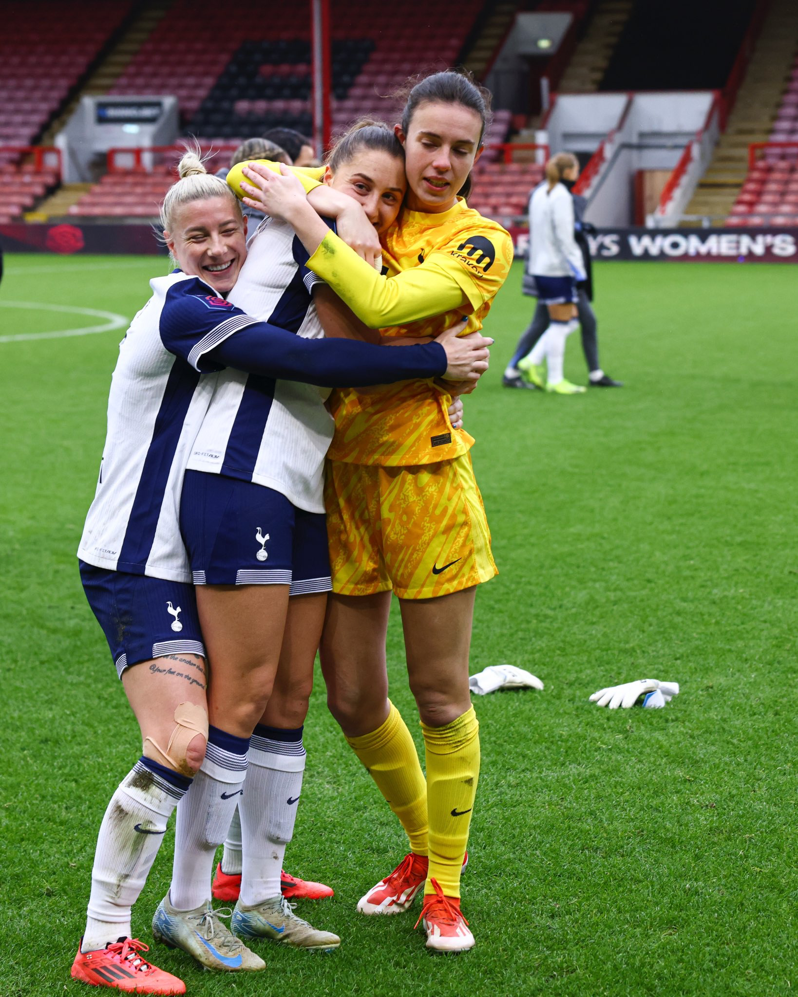 Ella Morris gets a group hug from Beth England and Eleanor Heeps.