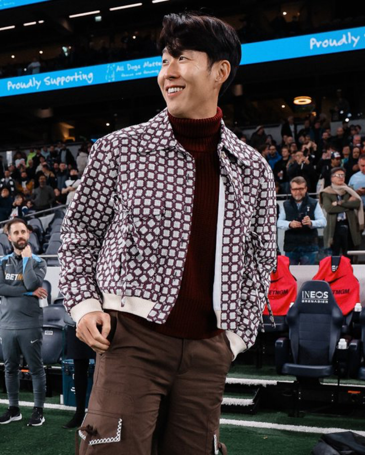 Son Heung-min wears a patterned bomber-style jacket over a turtleneck with cargo pants from S.S.DALEY.