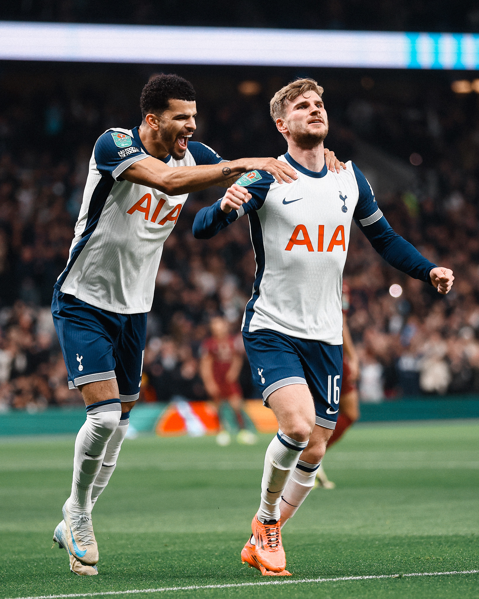 Dominic Solanke reaches for Timo Werner's shoulders as the winger celebrates his goal.