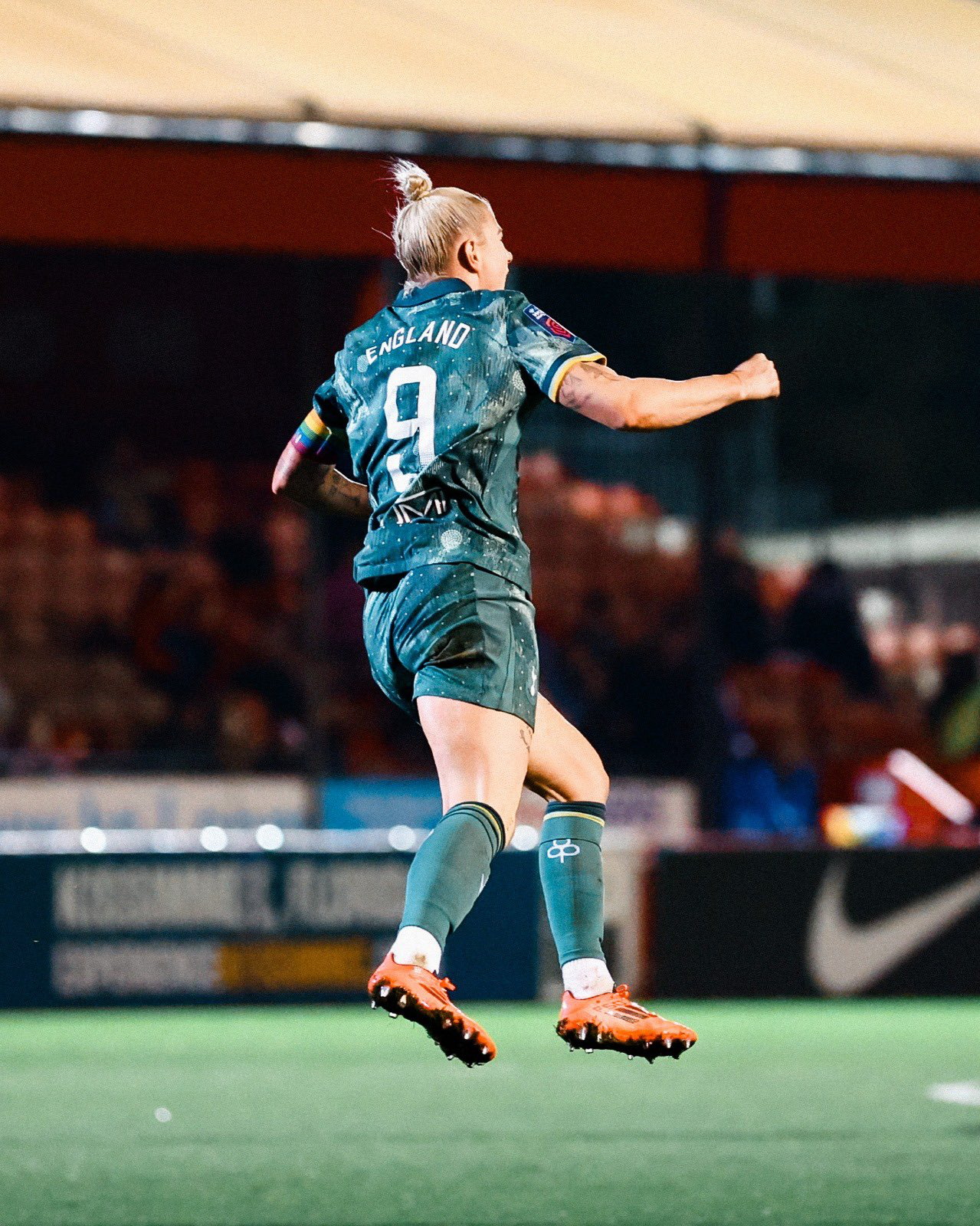 Beth England leaps up to celebrate her goal.