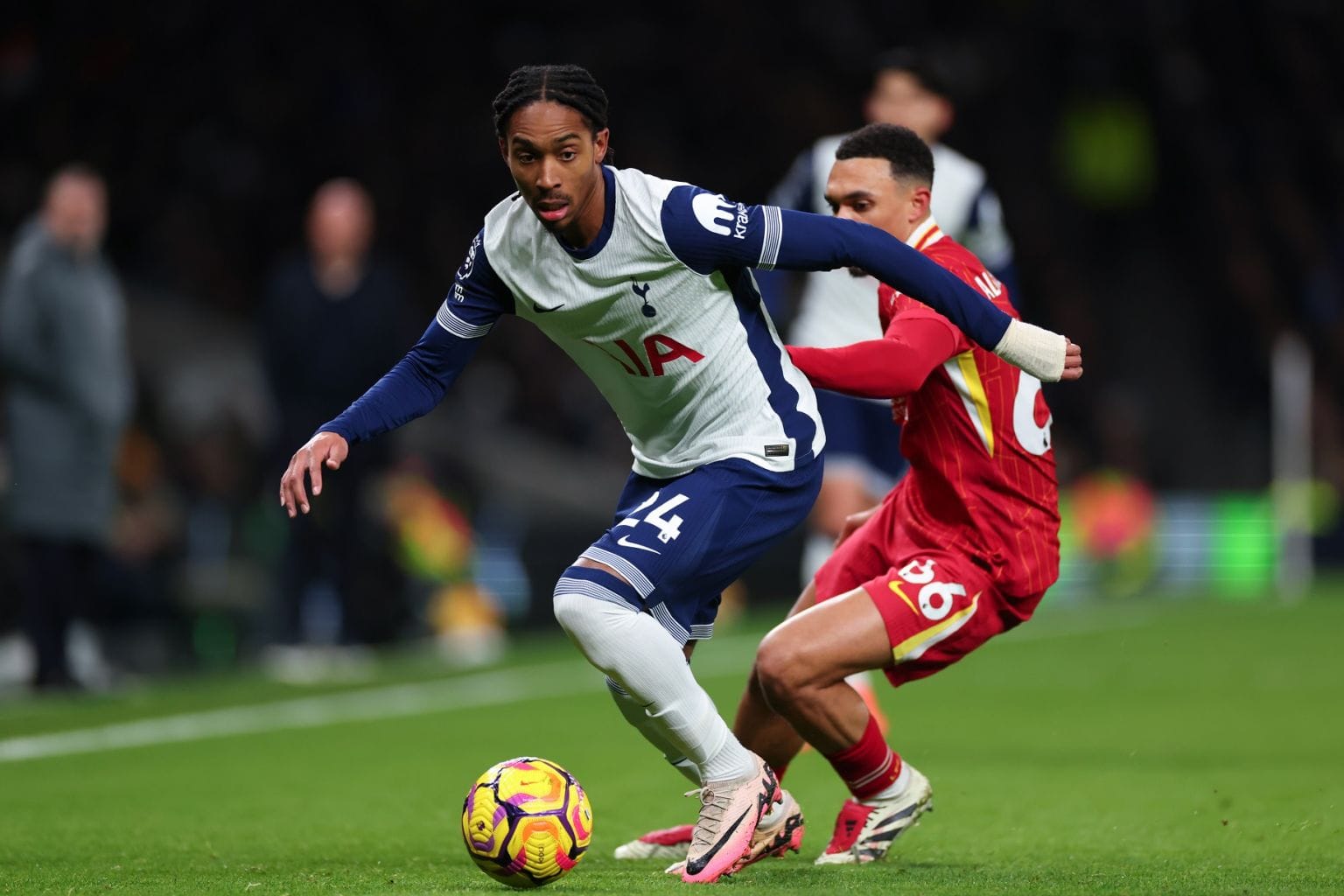 Djed Spence dribbles the ball away from Trent Alexander-Arnold.