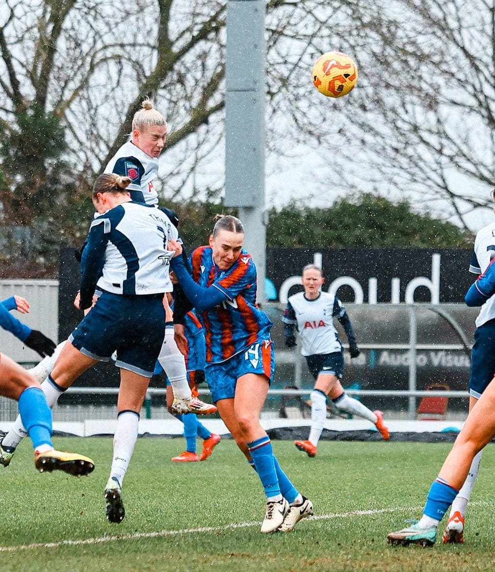 Beth England rises highest to head the ball into the net. 