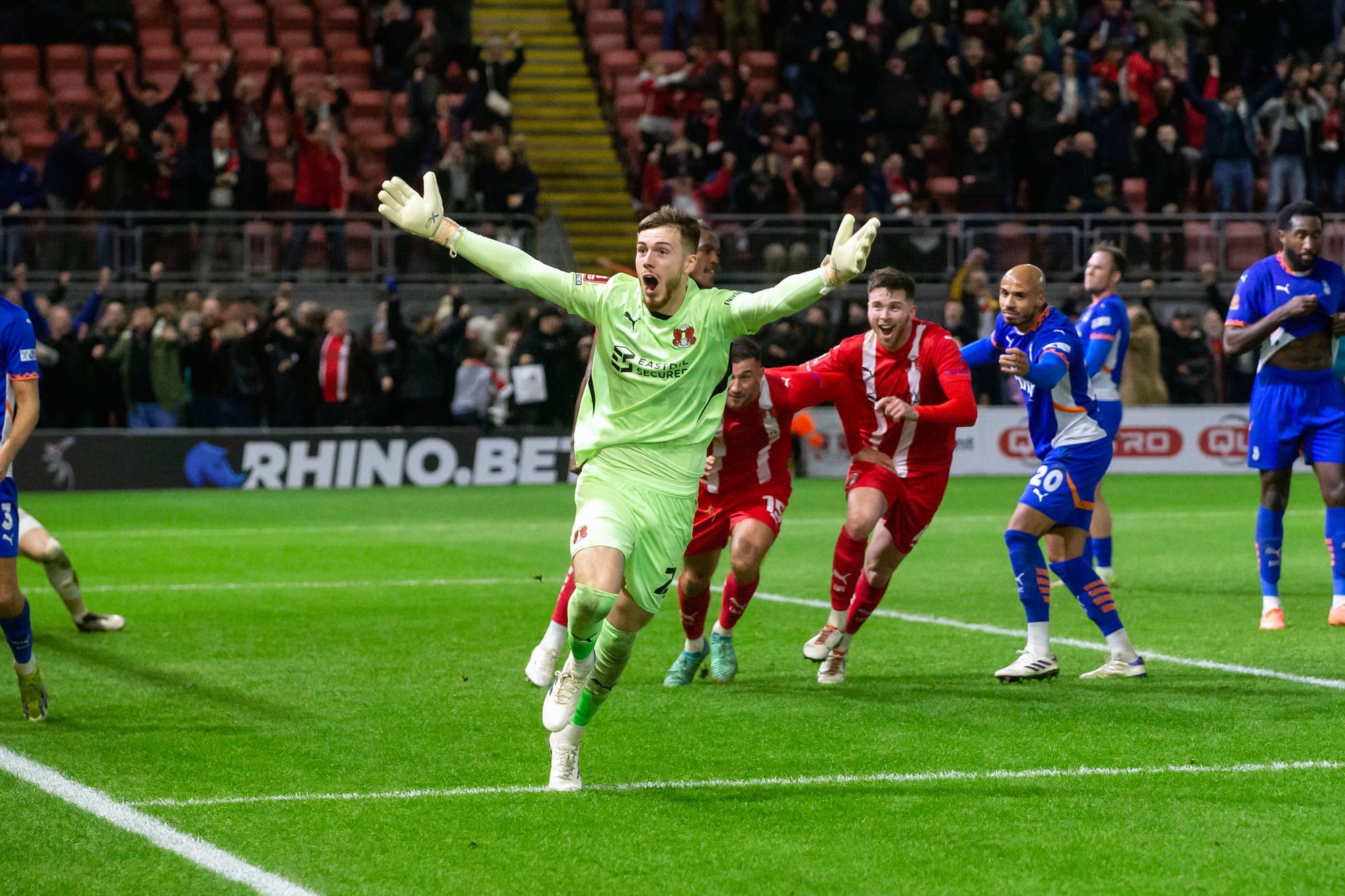 Josh Keeley celebrates his penalty save after Leyton Orient won the penalty shootout to advance in the FA Cup.