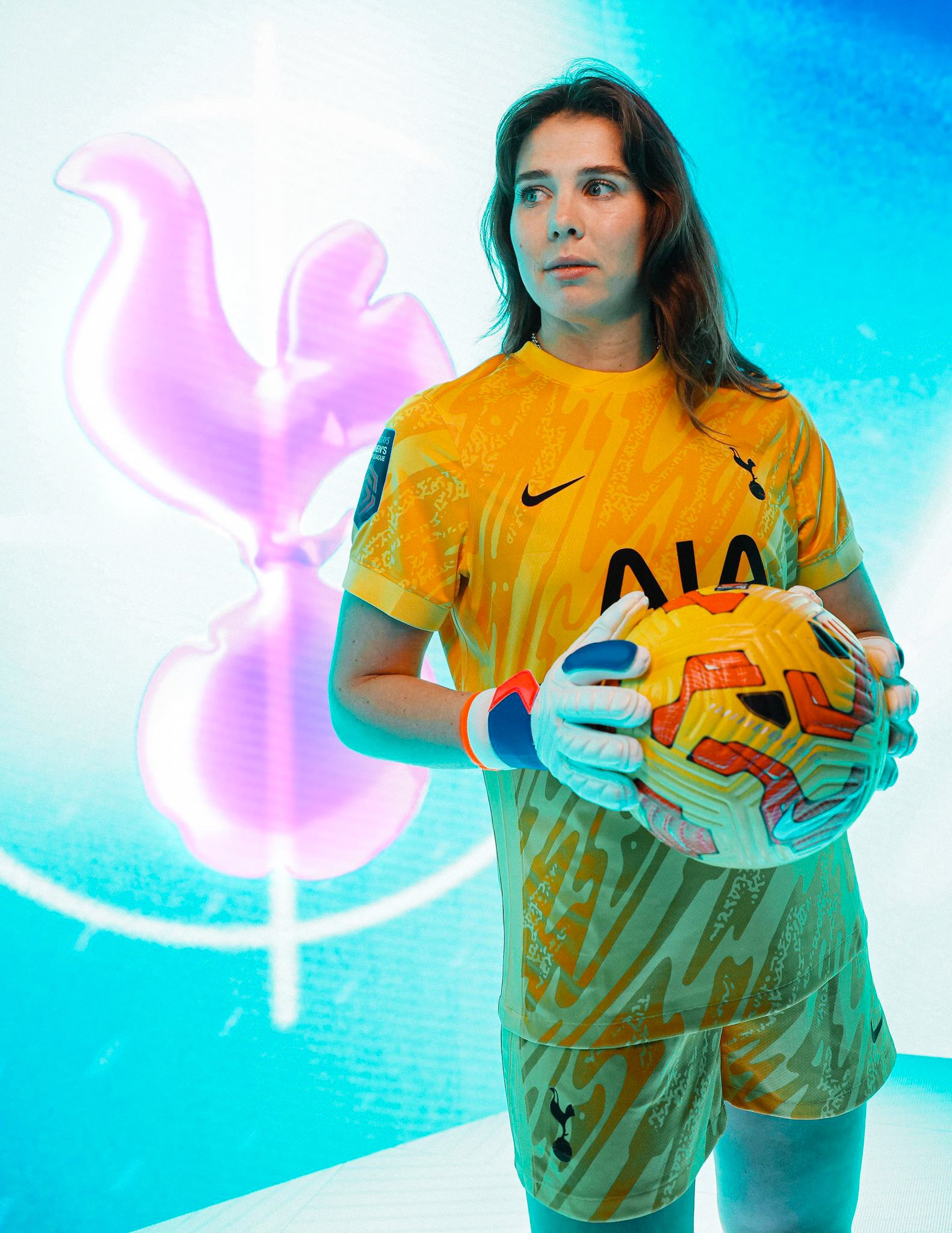 Lize Kop poses in her new Spurs goalkeeper kit with a ball in between her gloved hands.