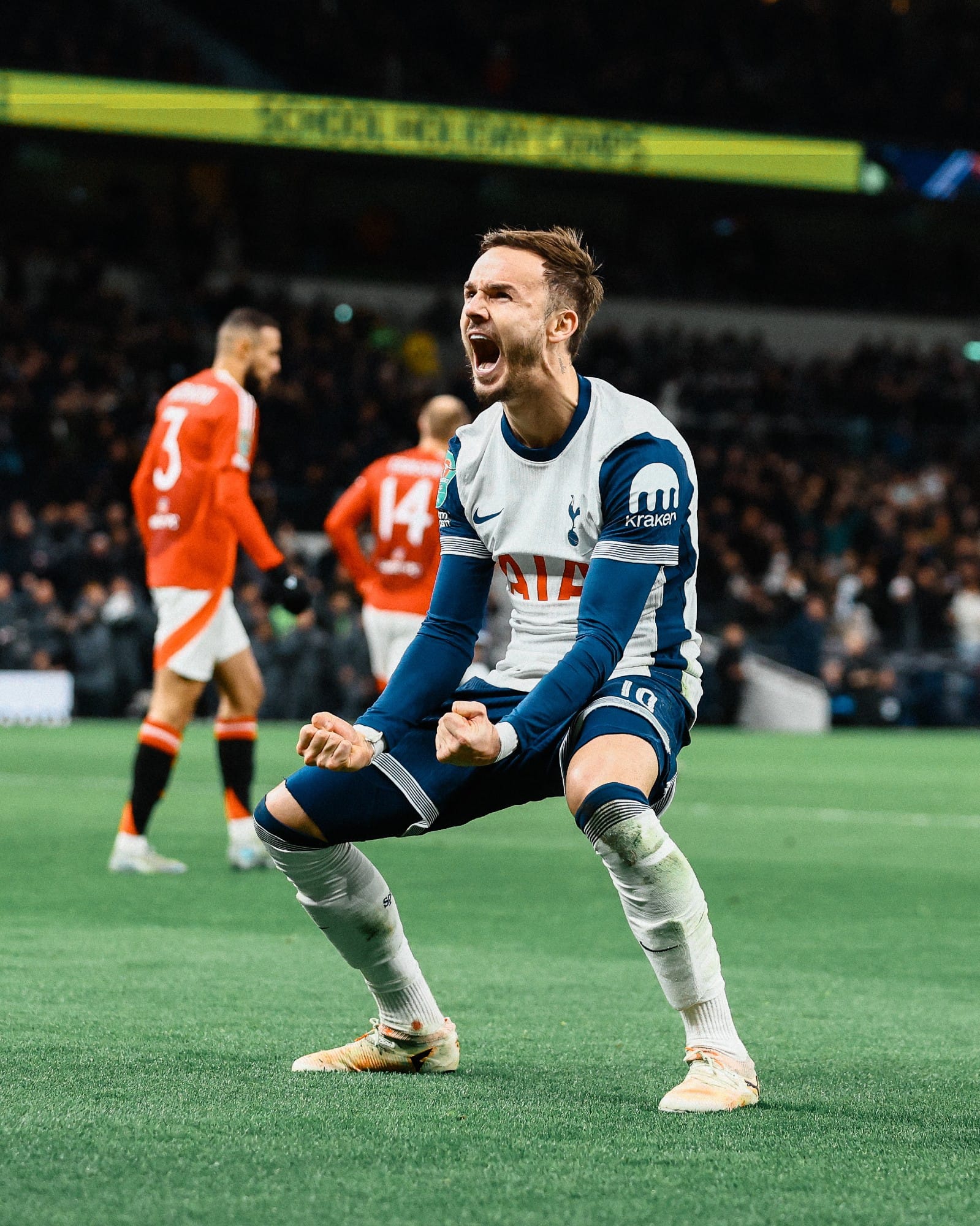 James Maddison crouches and roars to celebrate a goal.