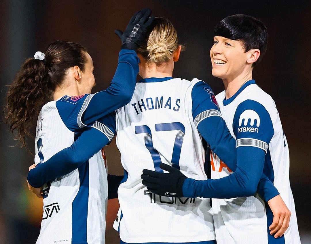 Hayley Raso and Ash Neville put their arms around Martha Thomas from behind to celebrate her goal.