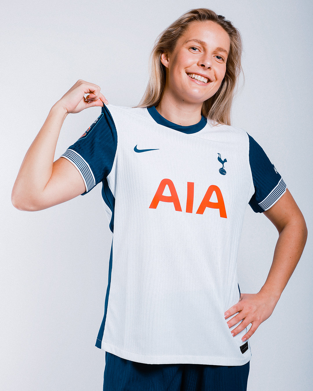 Olivia Hold holds up the shoulder of her new Spurs kit.