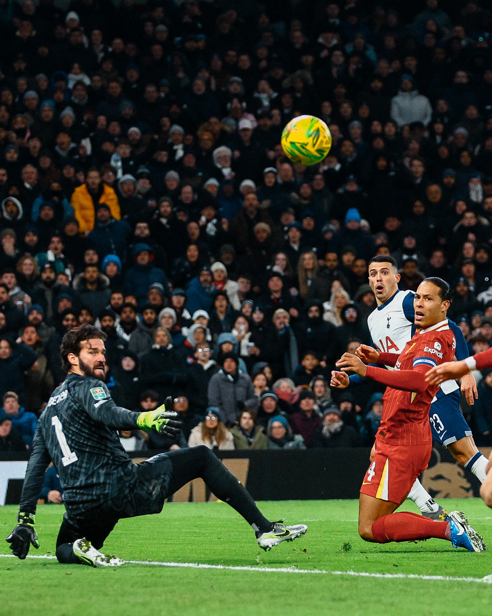 Pedro Porro looks surprised as his shot sails past Alisson and Virgil Van Dijk. 