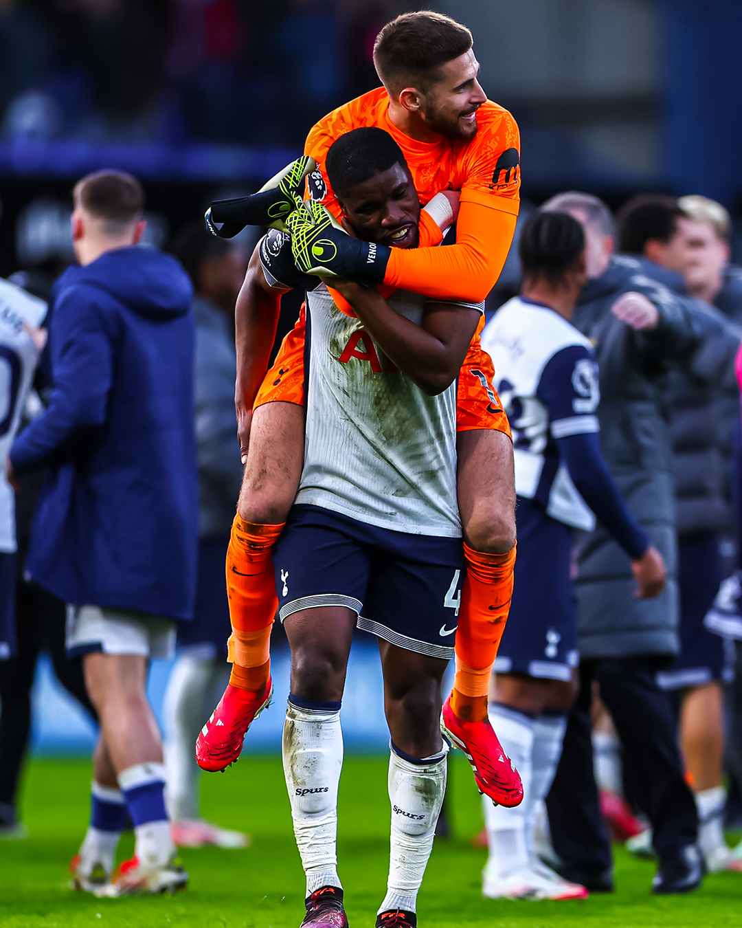 Guglielmo Vicario jumps on Kevin Danso's back to hug him.