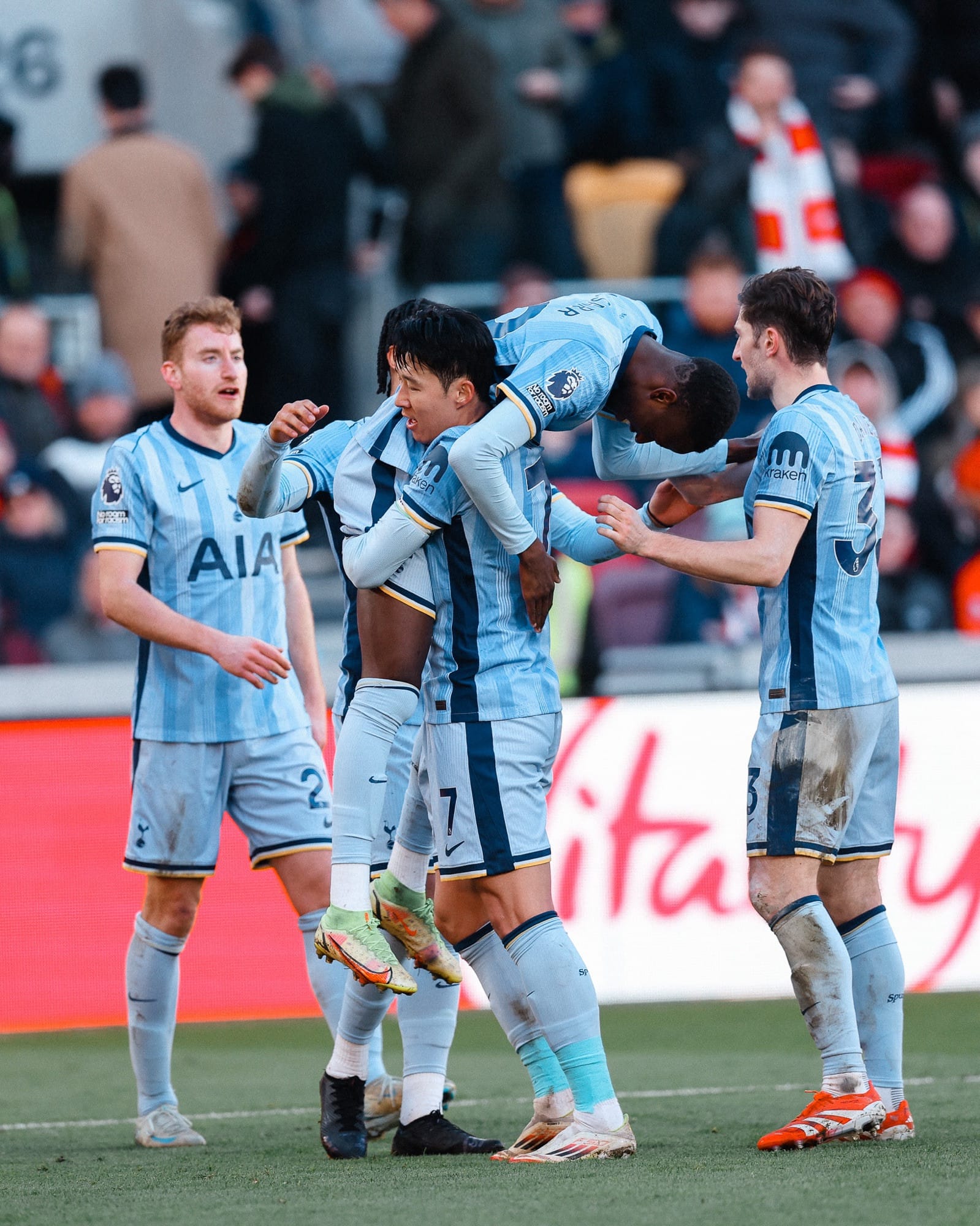 Pape Sarr is lifted into the air by Son Heung-min to celebrate his goal. 