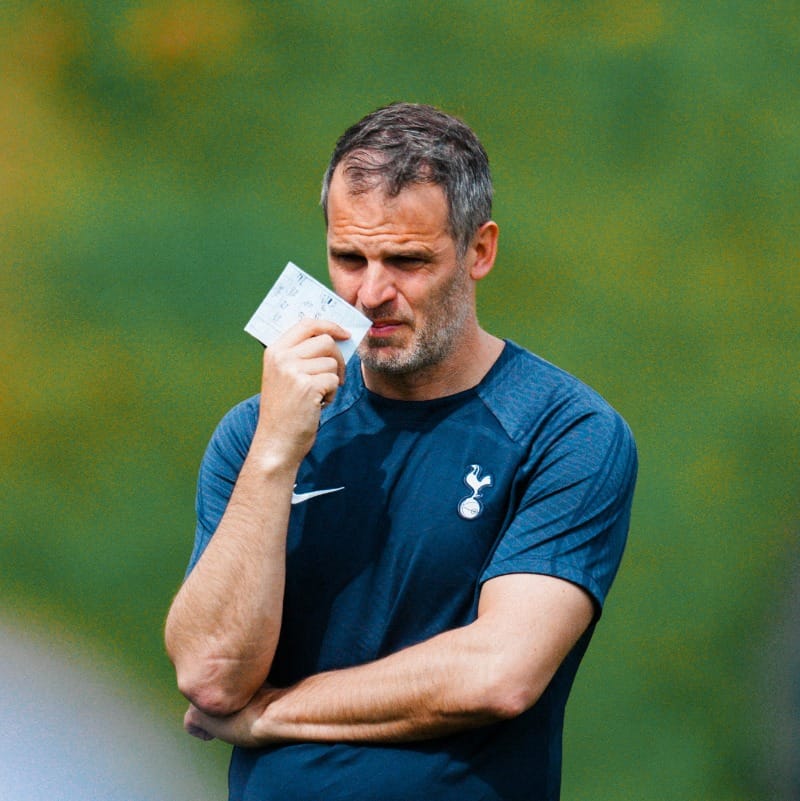 Robert Vilahamn crosses his arm with a note in his hand as he observes training.