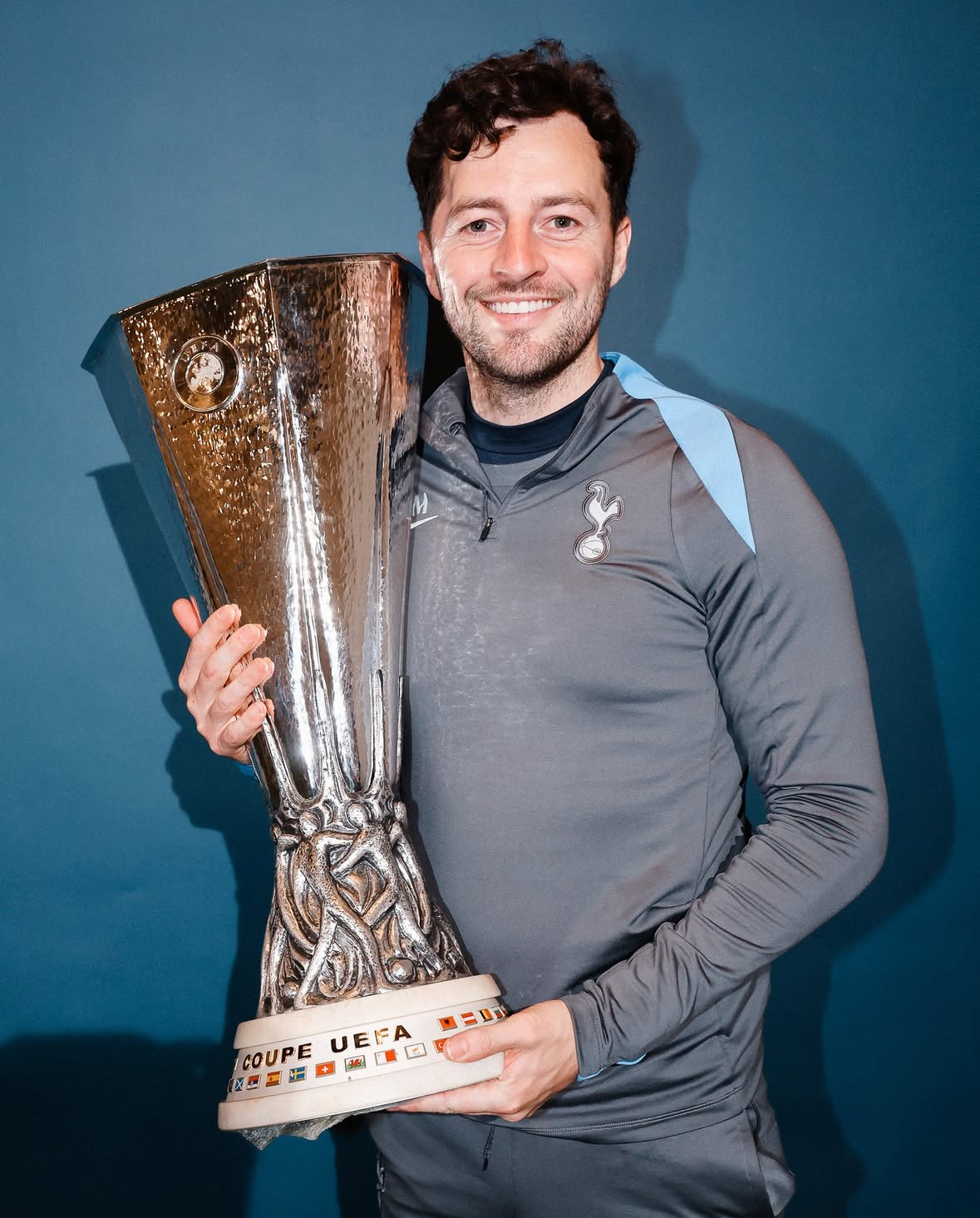 Ryan Mason poses with the Europa League trophy.