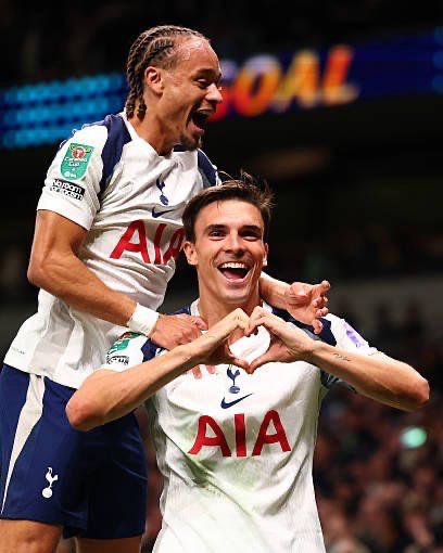 João Palhinha holds up a heart with his hands to celebrate his goal, while Xavi Simons jumps on his back.