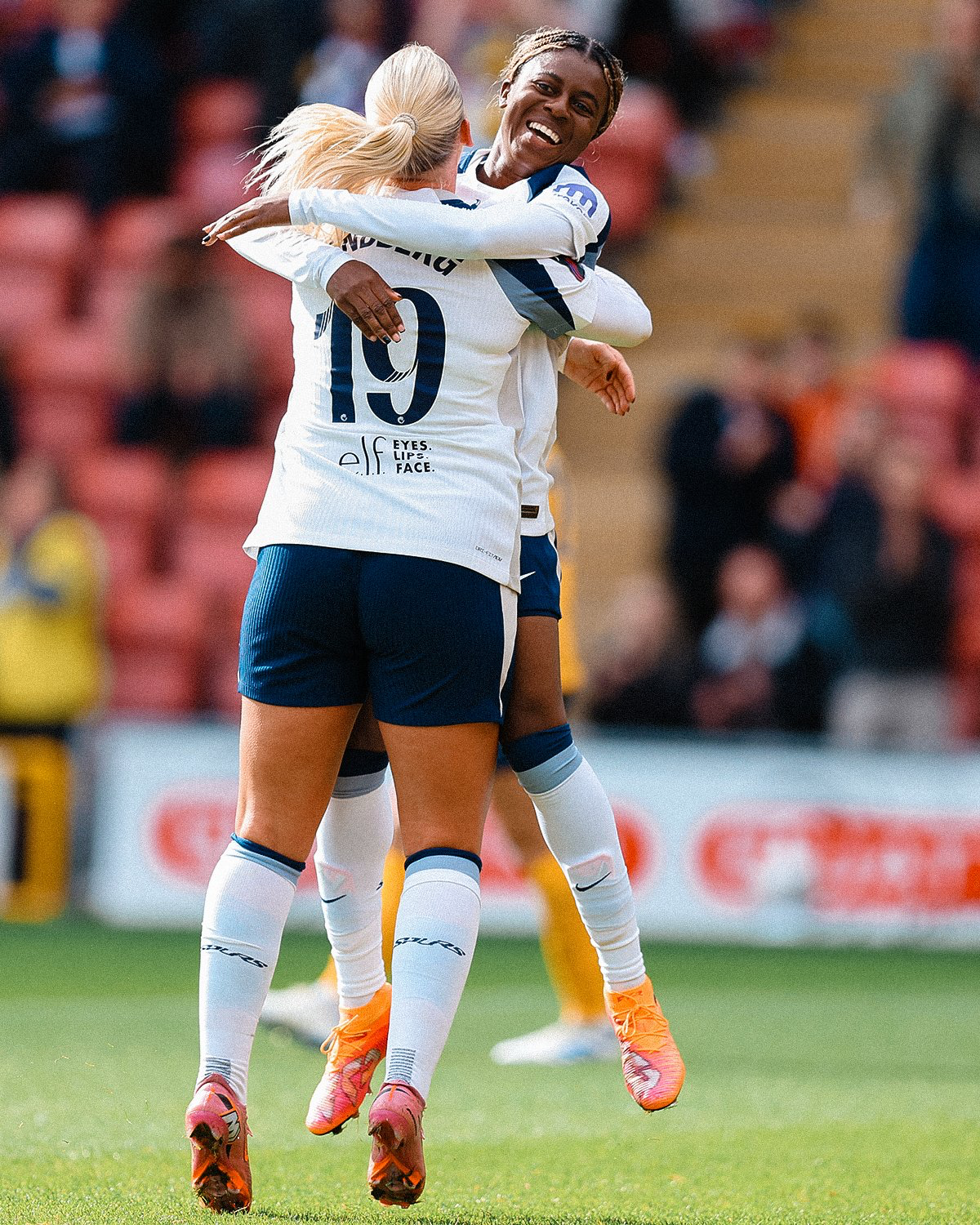 Jess Naz and Cathinka Tandberg leap up to hug each other.
