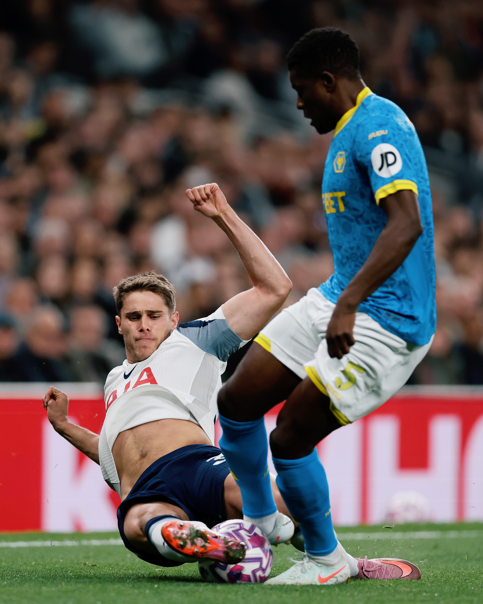 Micky van de Ven goes in for a slide tackle on Wolves' Marshall Munetsi.
