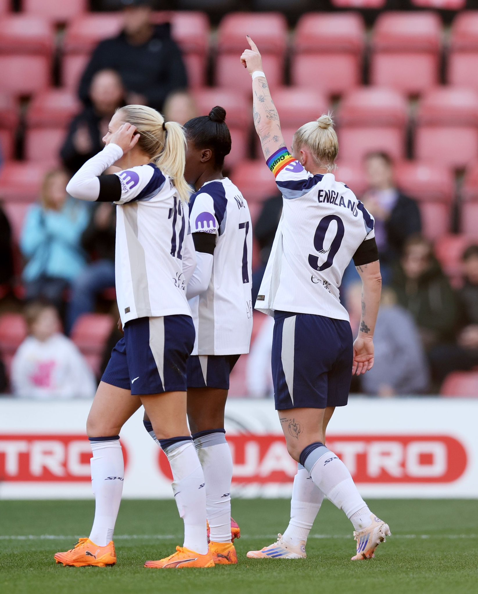 Beth England points up after scoring.